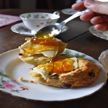 King Charles's Scones on a plate spread with butter and homemade marmalade